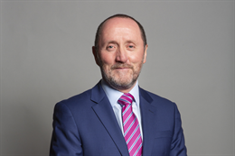 3:2 portrait of Eddie Hughes